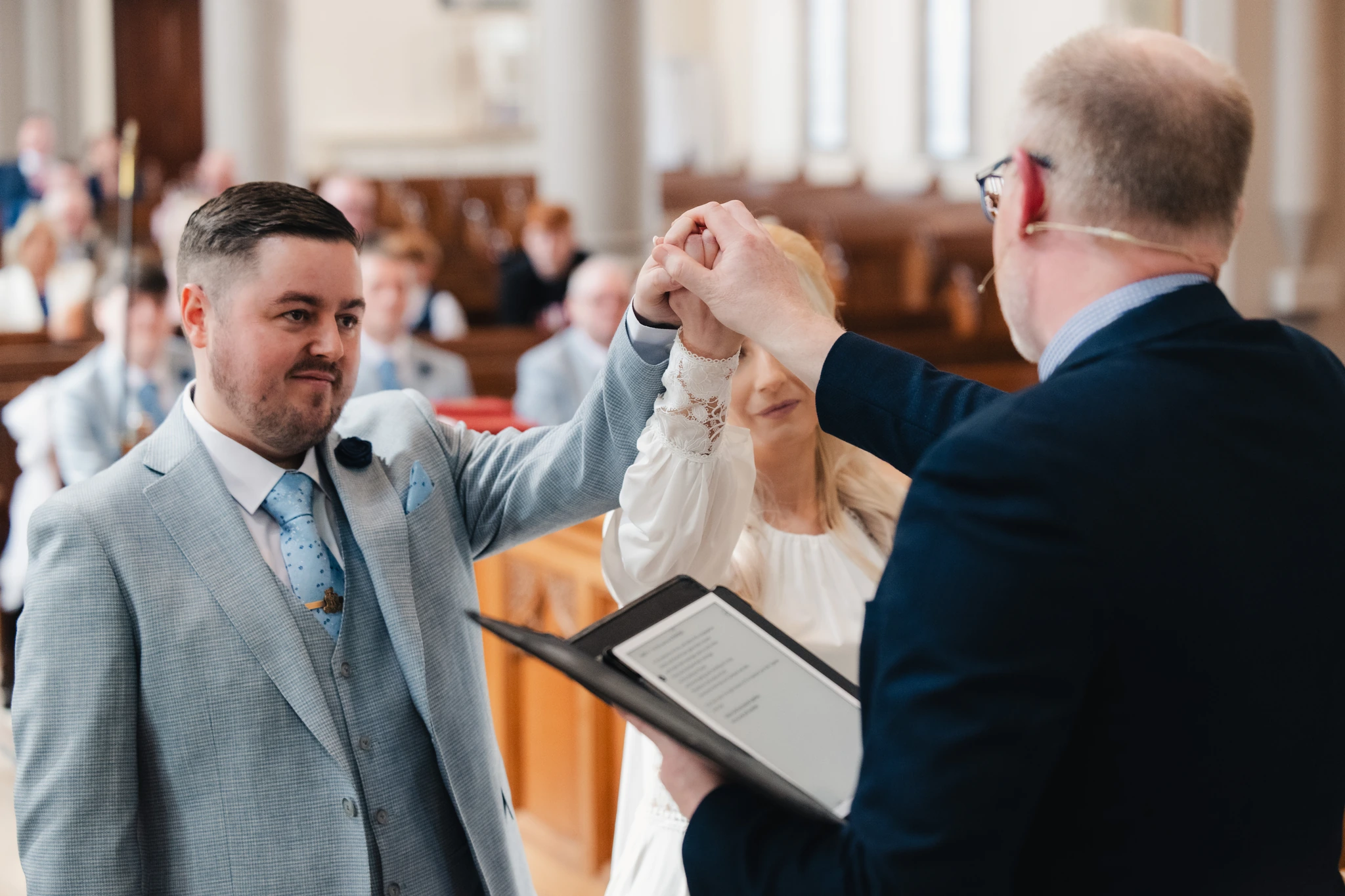 a bride and groom shake hands at the end of their wedding ceremony