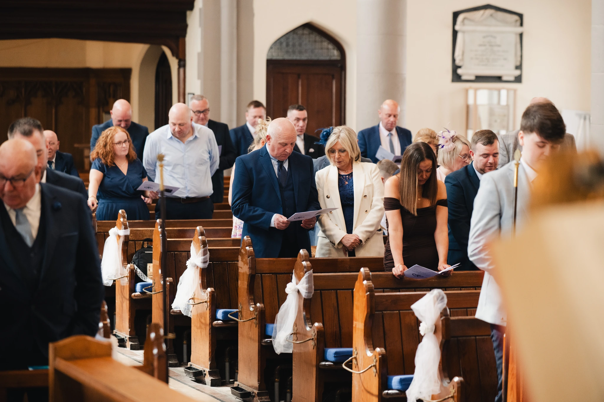 a bride and groom walk down the aisle of a church
