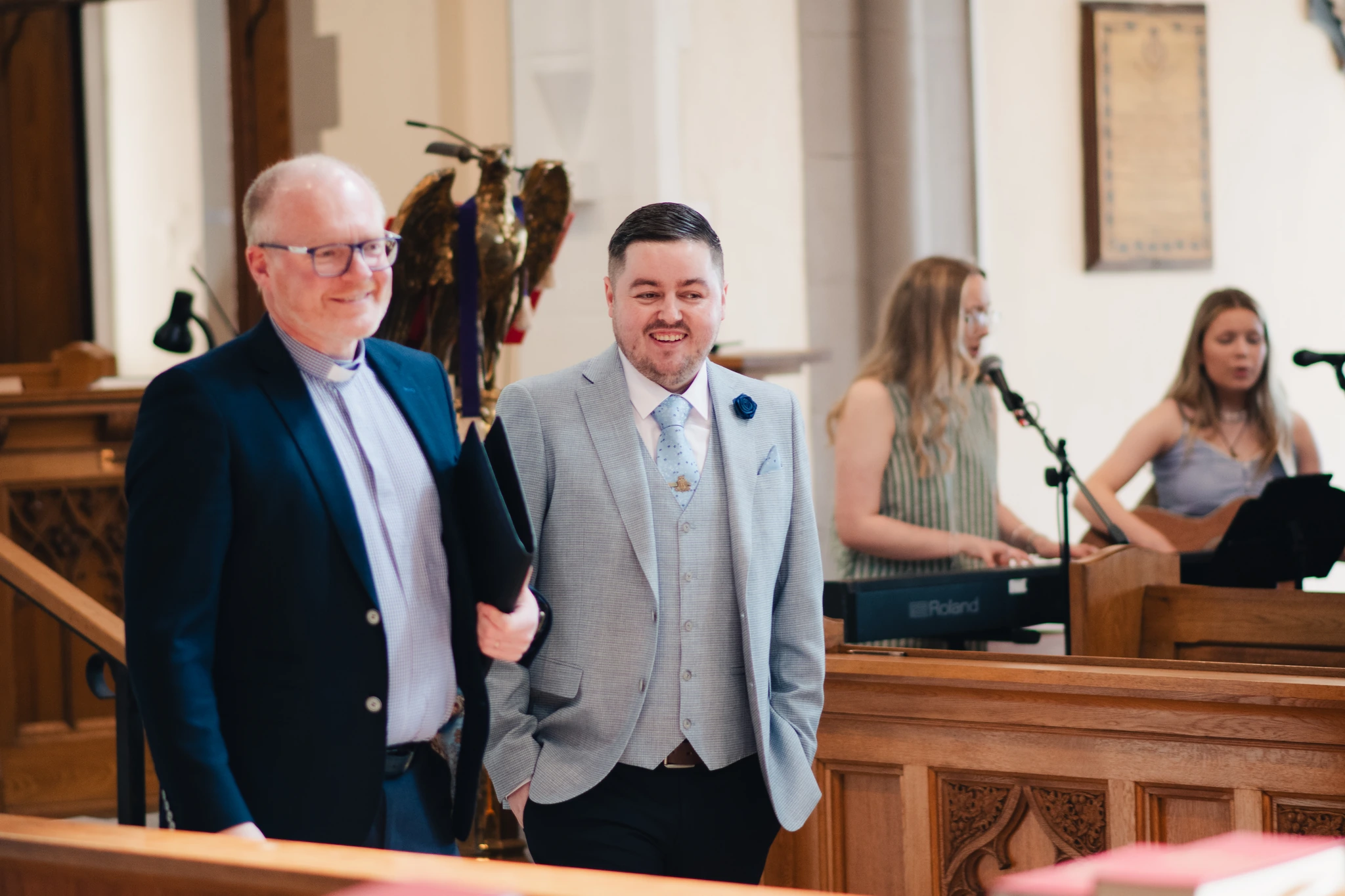 a bride and groom walk down the aisle of a church