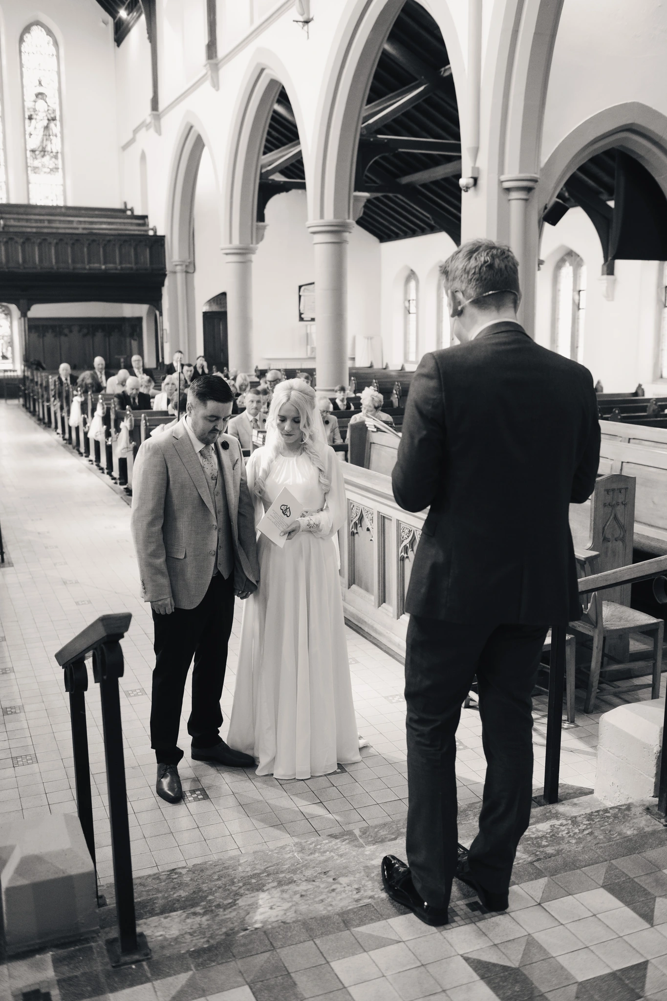 a bride walks down the aisle of a church