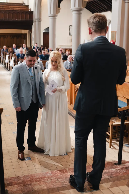a bride walks down the aisle of a church