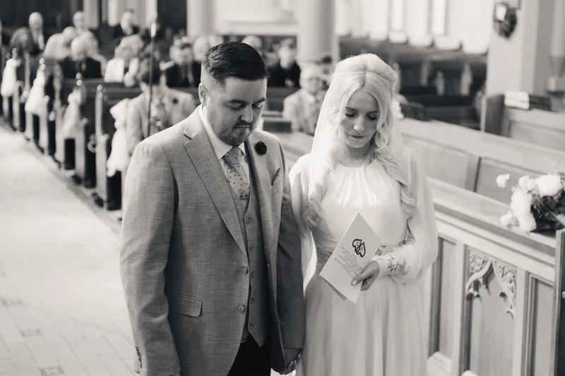 a bride and groom walk down the aisle of a church