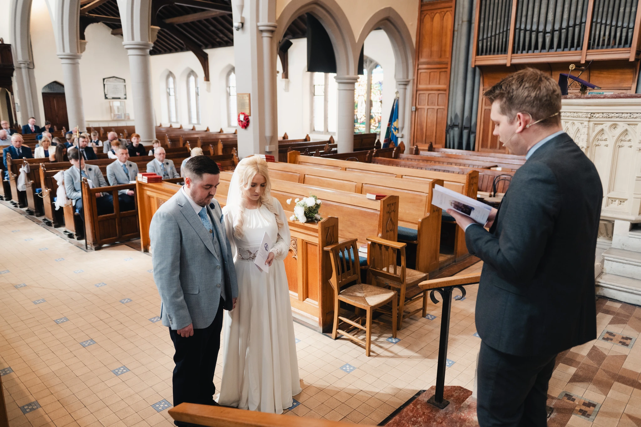 a bride walks down the aisle of a church during her wedding ceremony