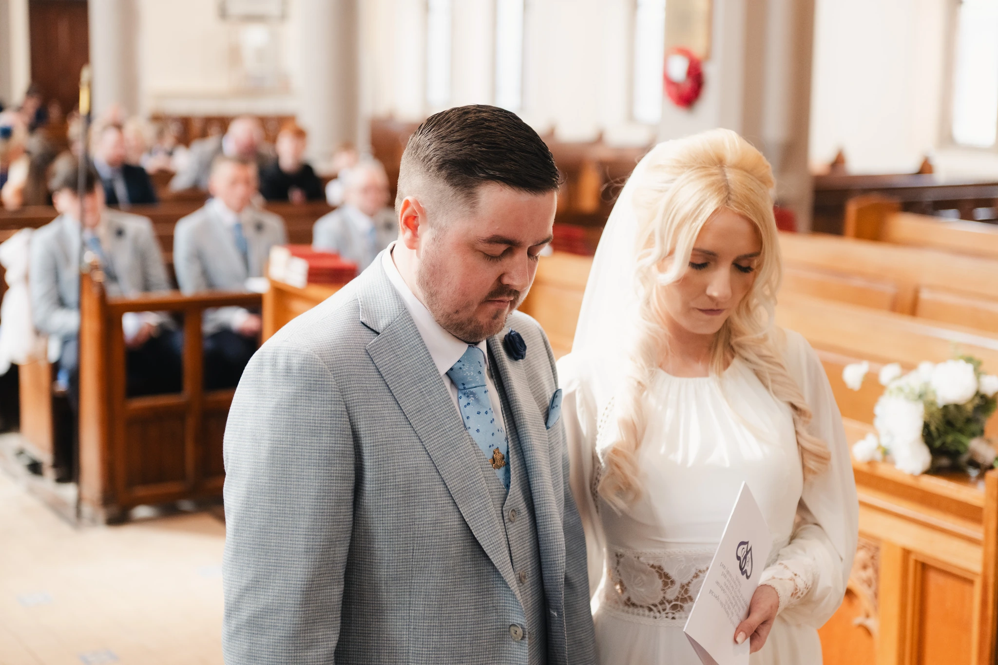 a bride and groom walk down the aisle of a church