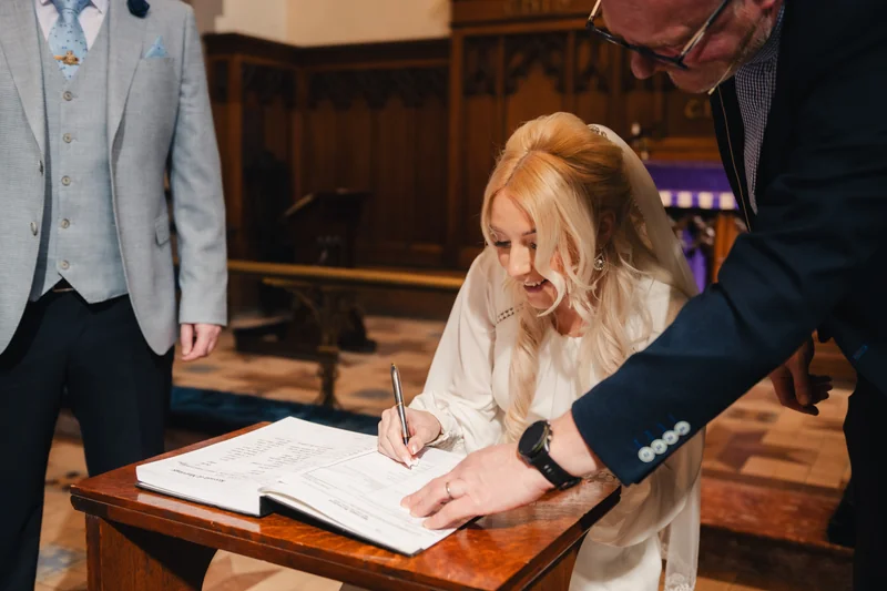 a bride signing her wedding vows in a church