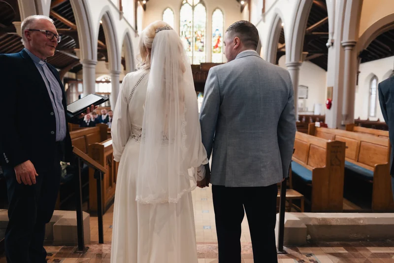 a bride and groom walk down the aisle of a church