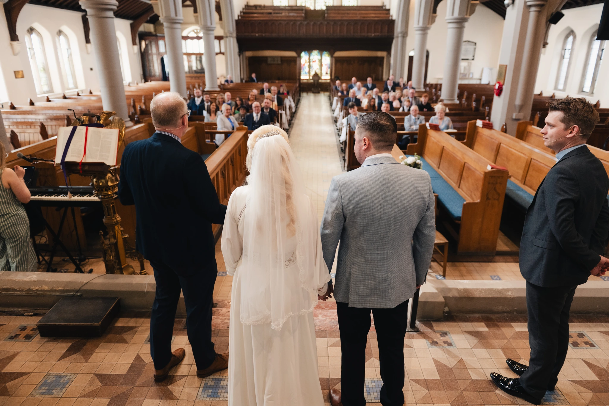 a bride and groom walk down the aisle of a church