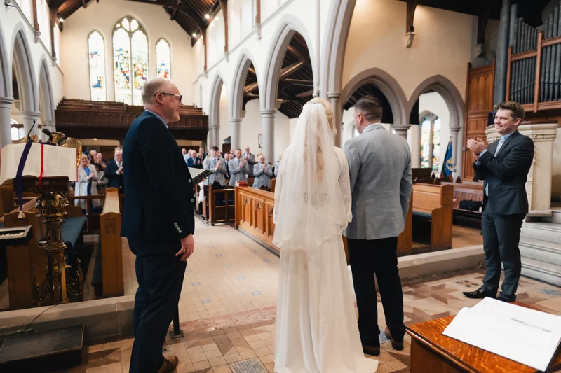 a bride walks down the aisle of a church