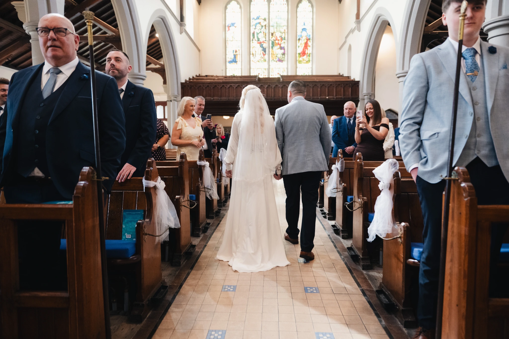 a bride walks down the aisle of a church