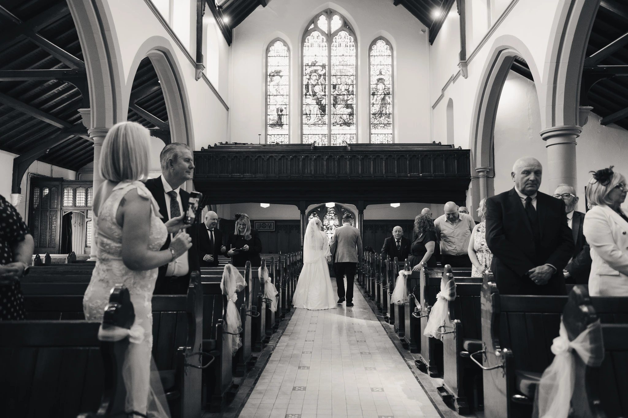 a bride walks down the aisle of a church