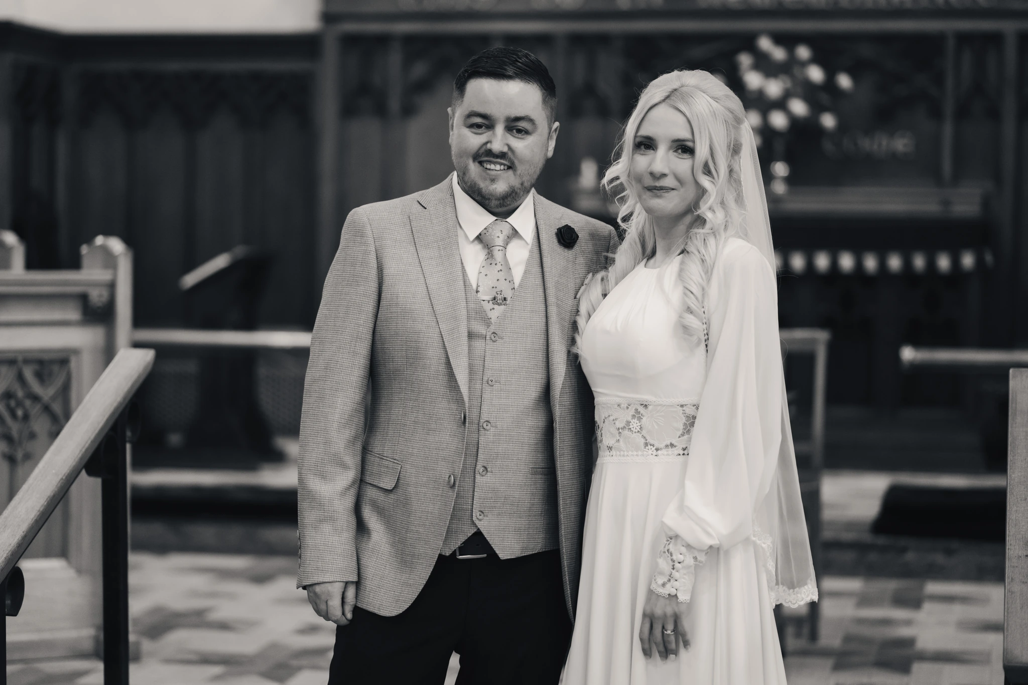 a bride and groom standing in front of a church