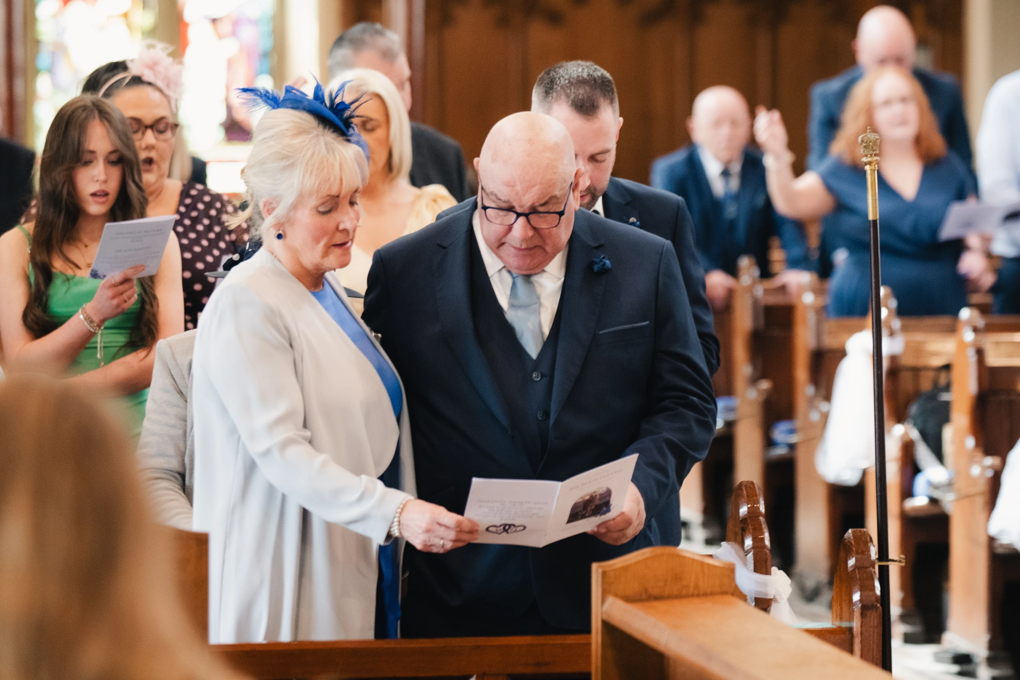 a bride and groom walk down the aisle of a church