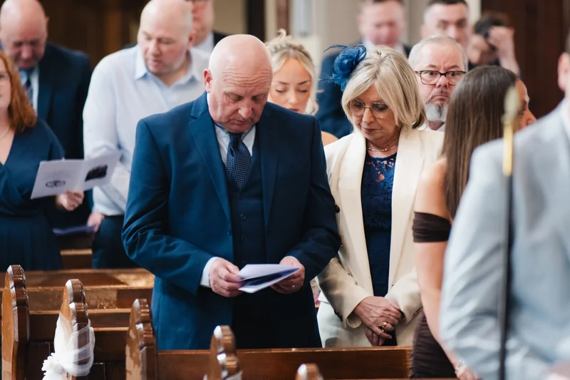 a bride and groom walk down the aisle of a church