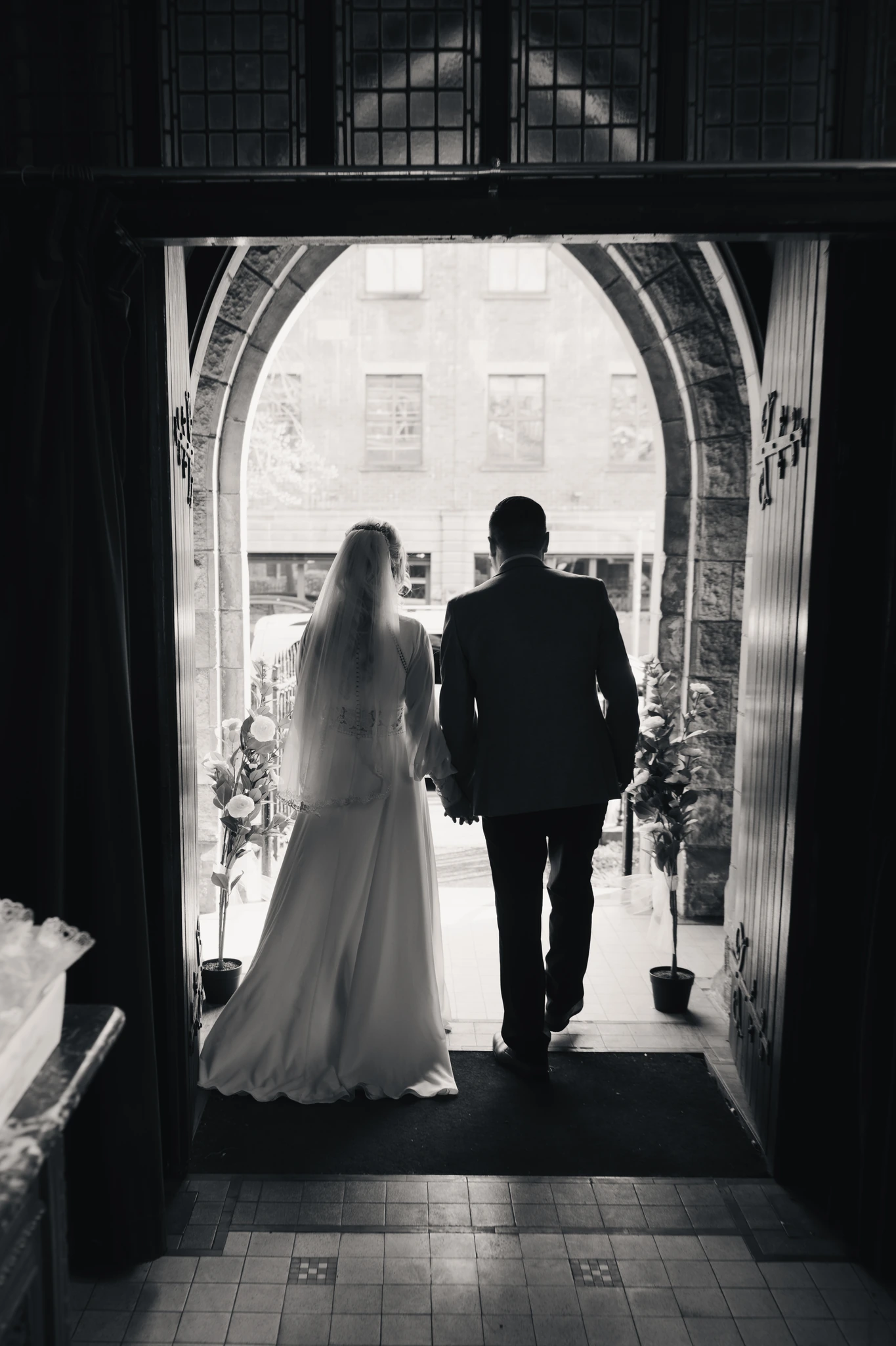 a bride and groom walk down the aisle of a church