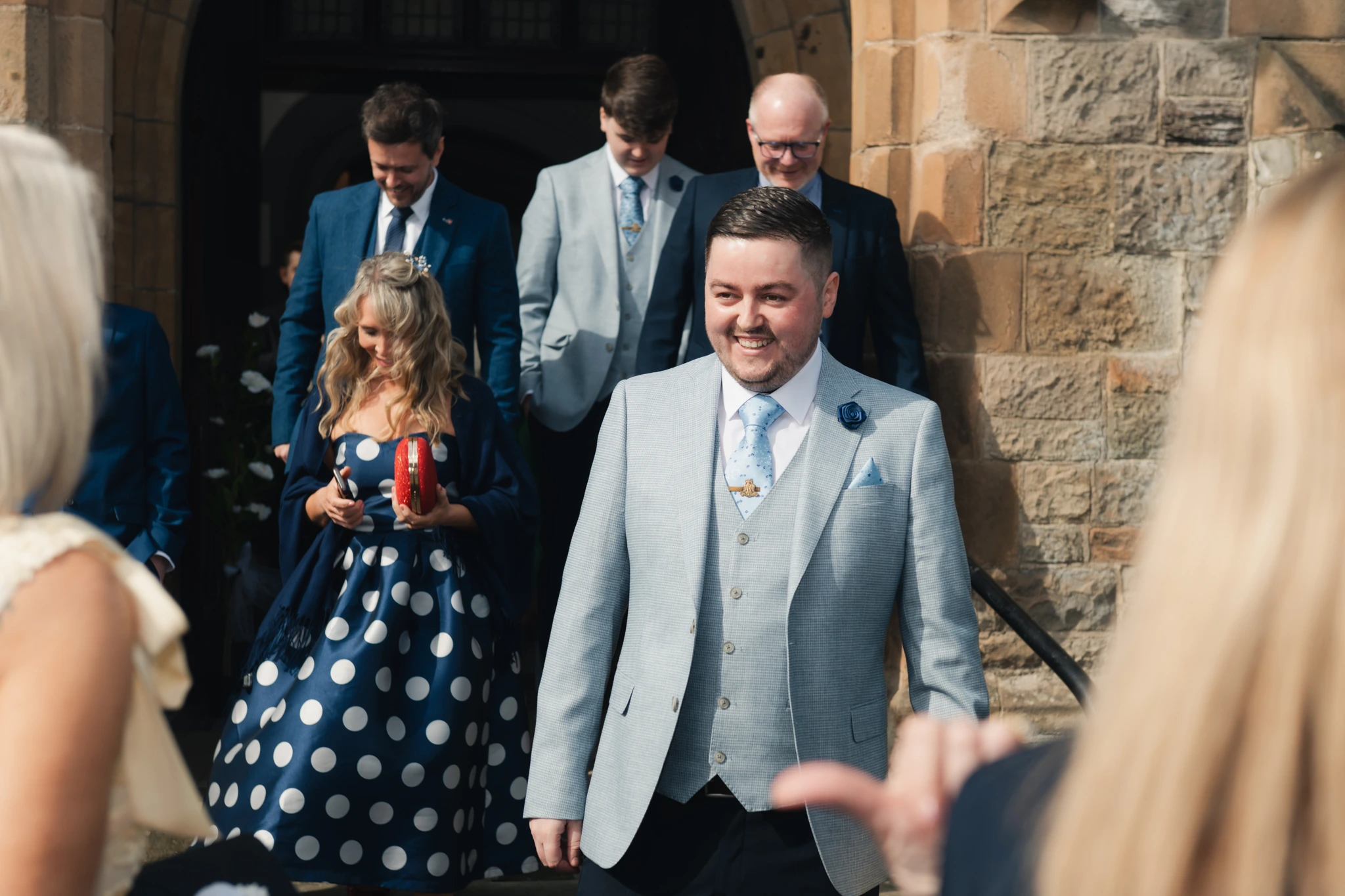 a bride and groom walk down the aisle of a church