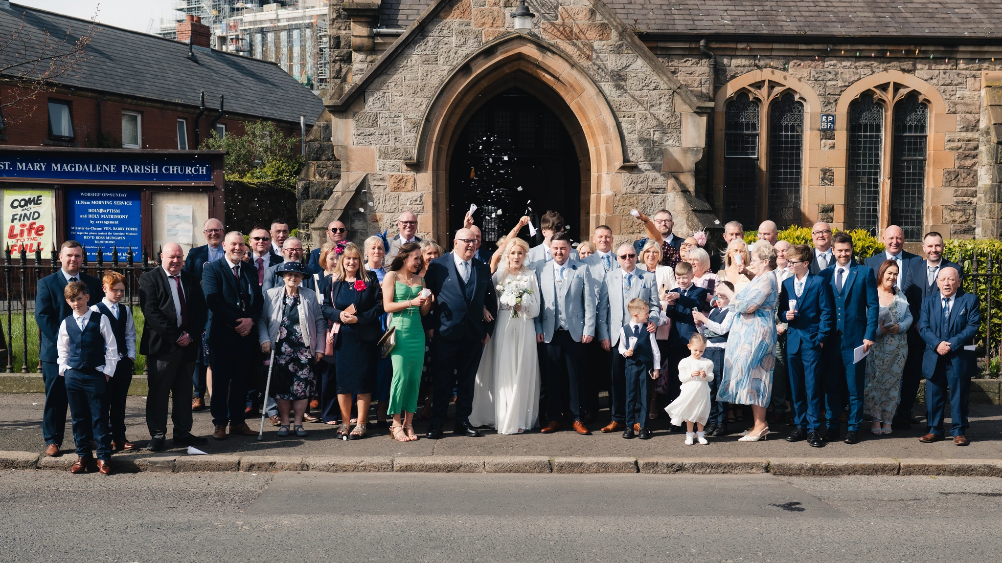 a wedding party in front of a church