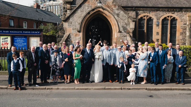 a wedding party in front of a church