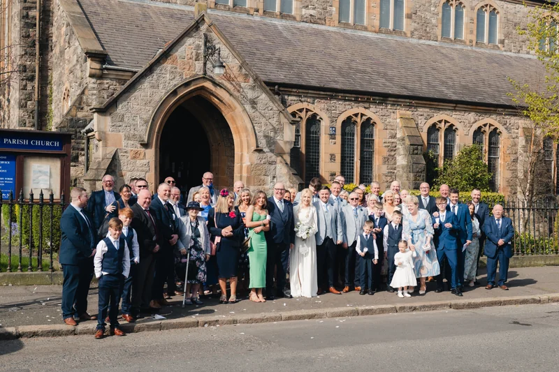a wedding party in front of a church