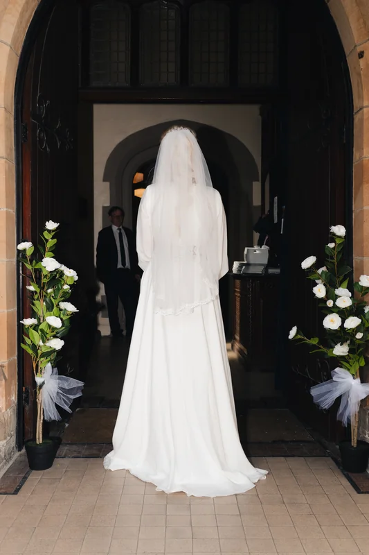 a bride walks down the aisle of a church