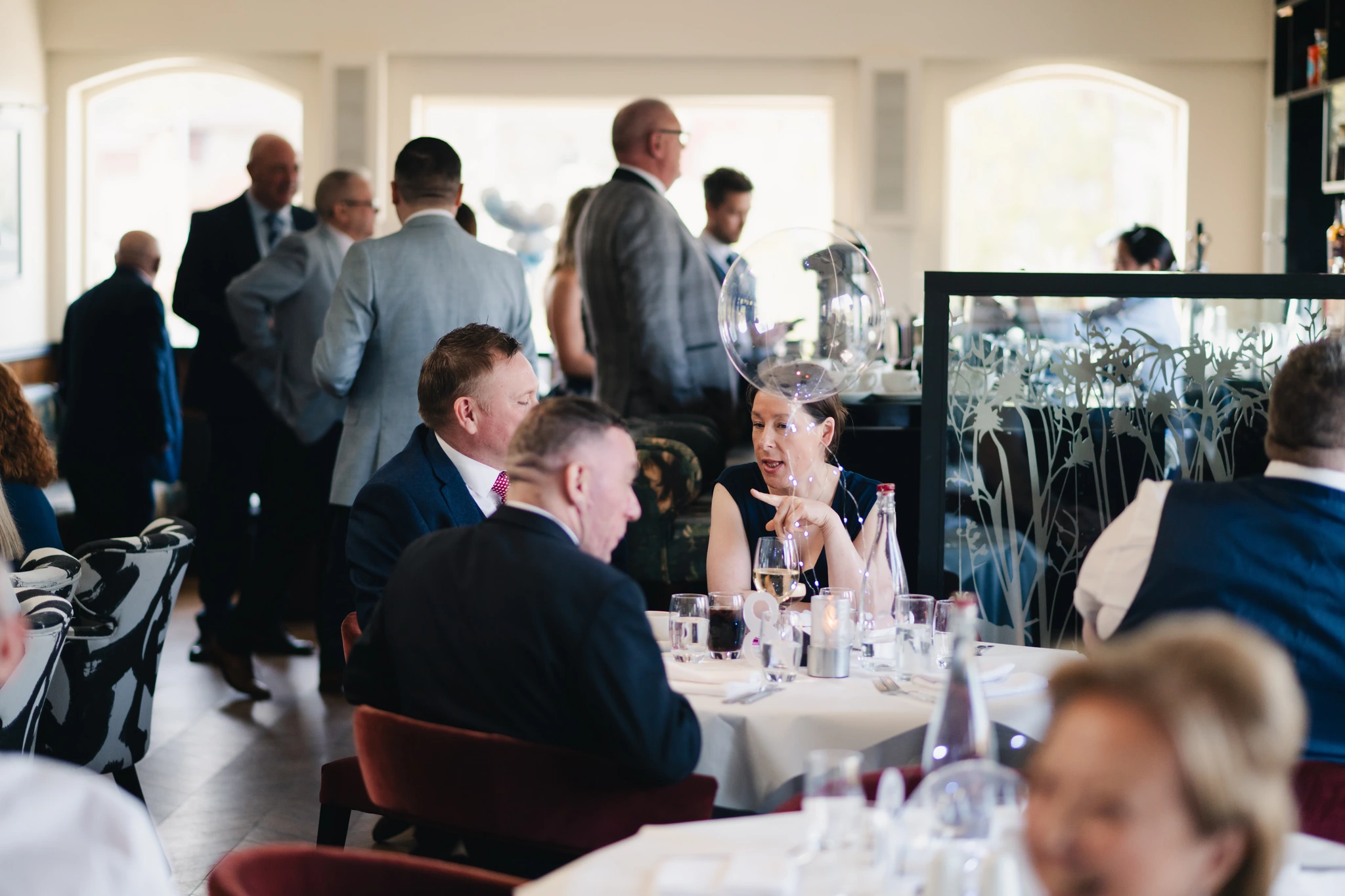 a group of people sitting at a table in a restaurant