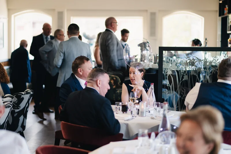 a group of people sitting at a table in a restaurant