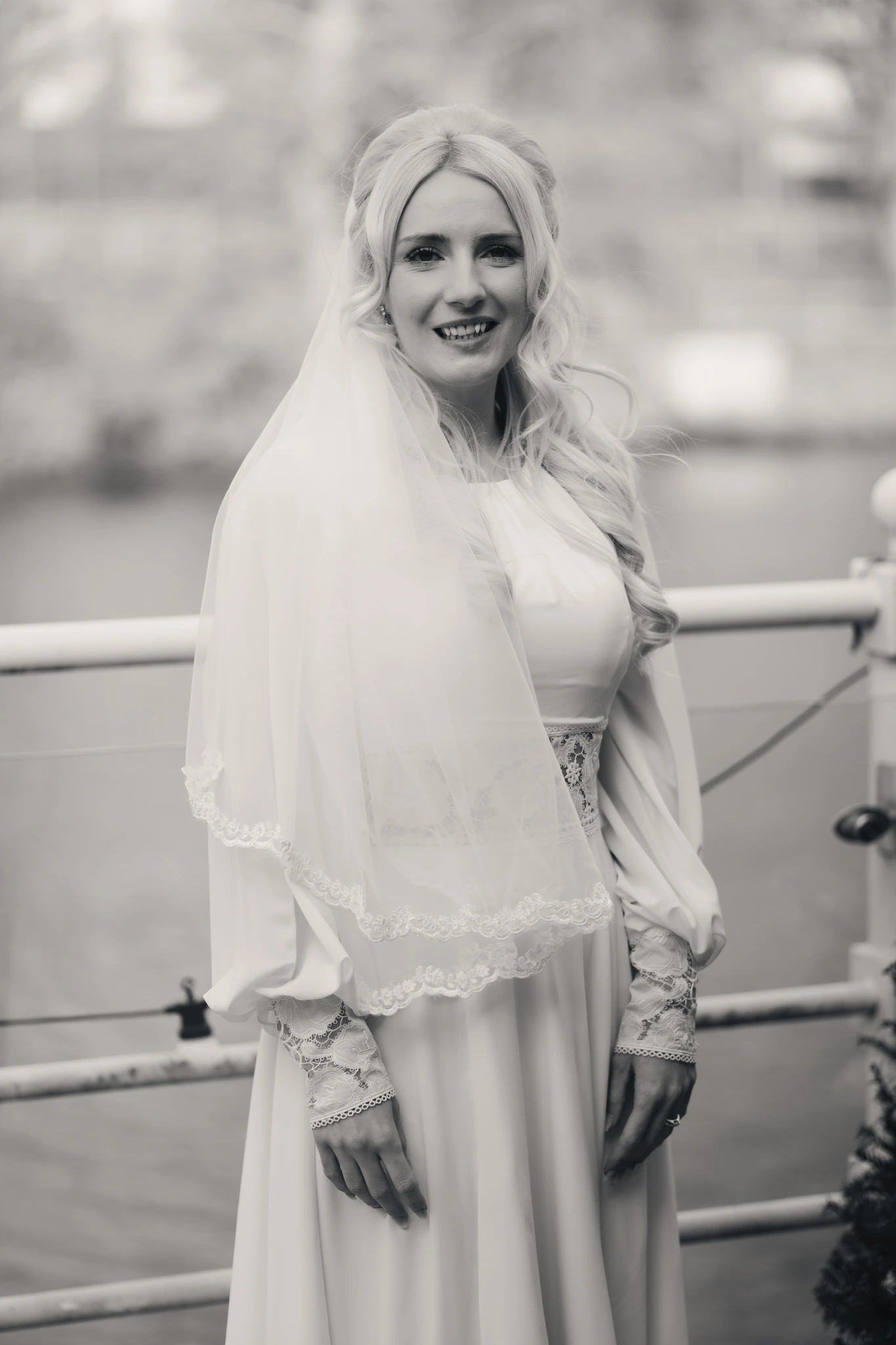 a bride in a white wedding dress with a veil and tiara