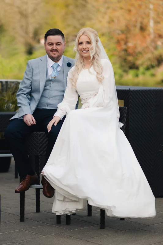 a bride and groom posing for a photo at their wedding reception