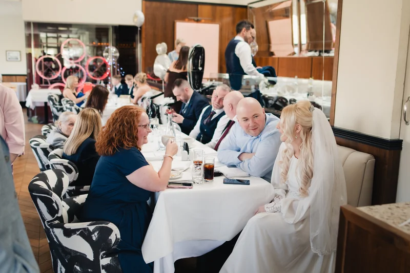 a group of people sitting at a table in a restaurant