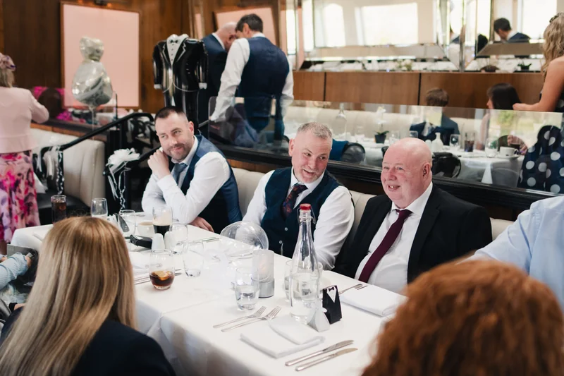 a group of people sitting at a table in a restaurant