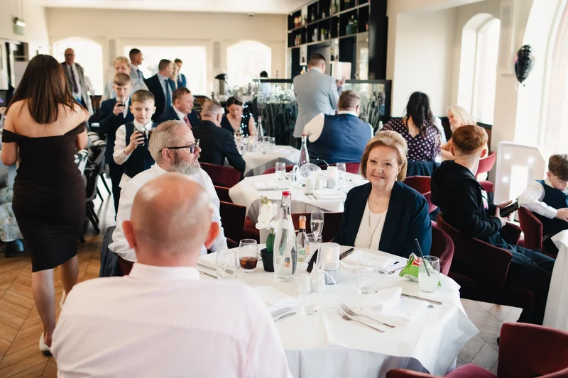 a group of people sitting at a table in a restaurant