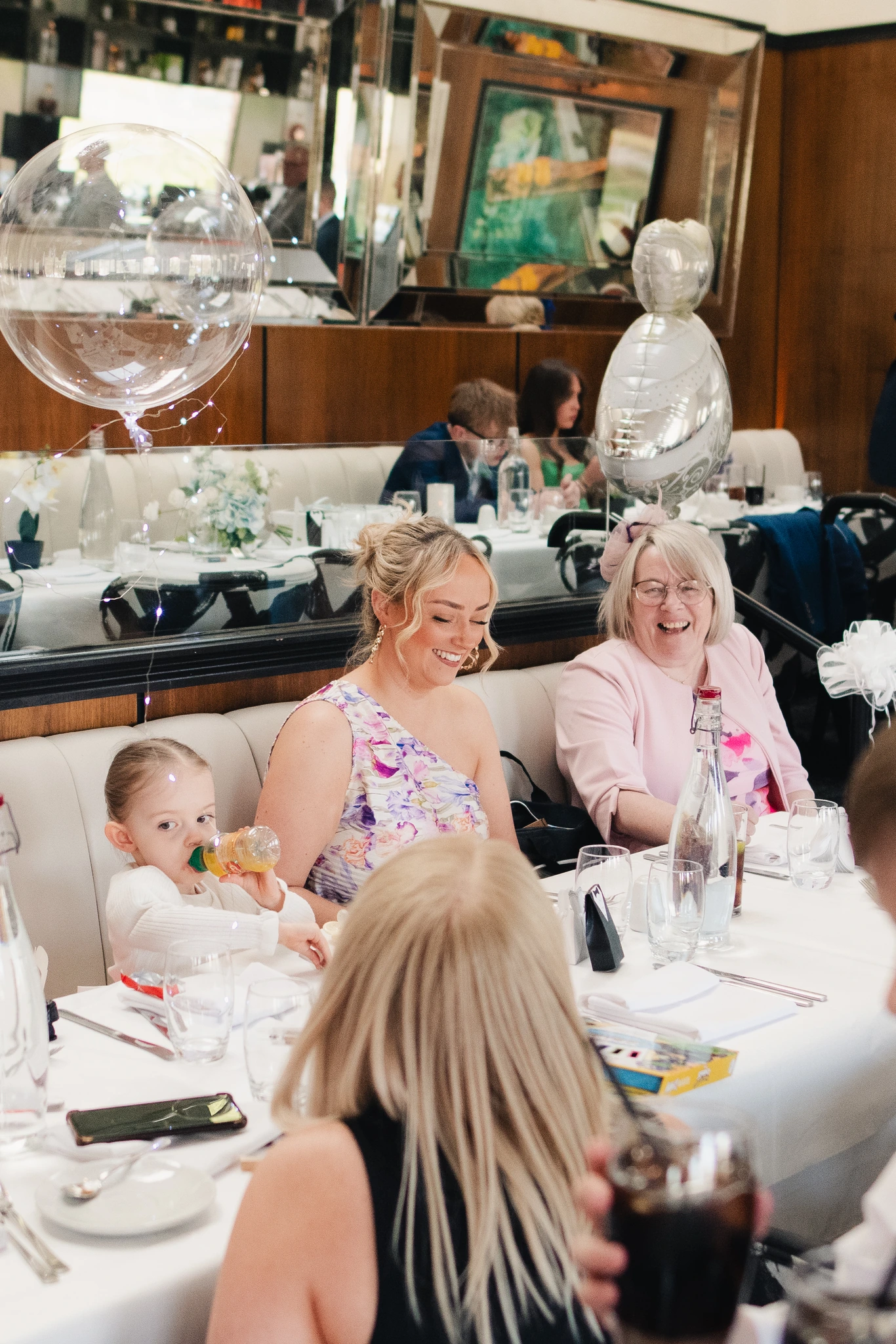 a group of people sitting at a table in a restaurant