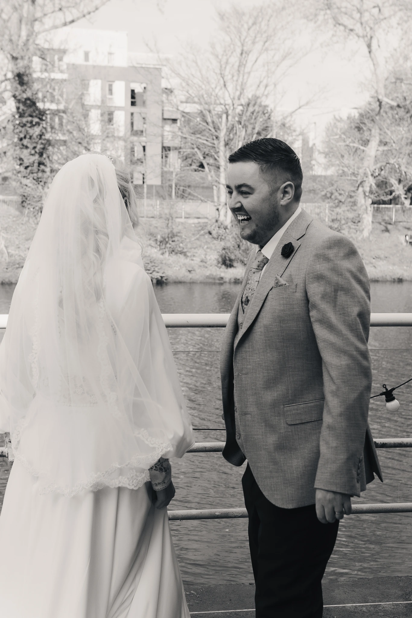 a bride and groom look at each other as they walk down the aisle