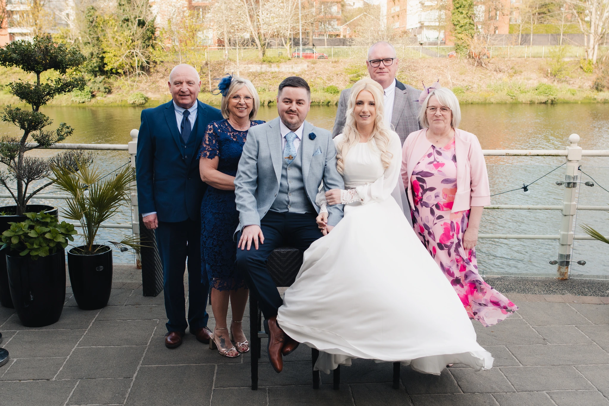 a group of family and friends posing in front of a river