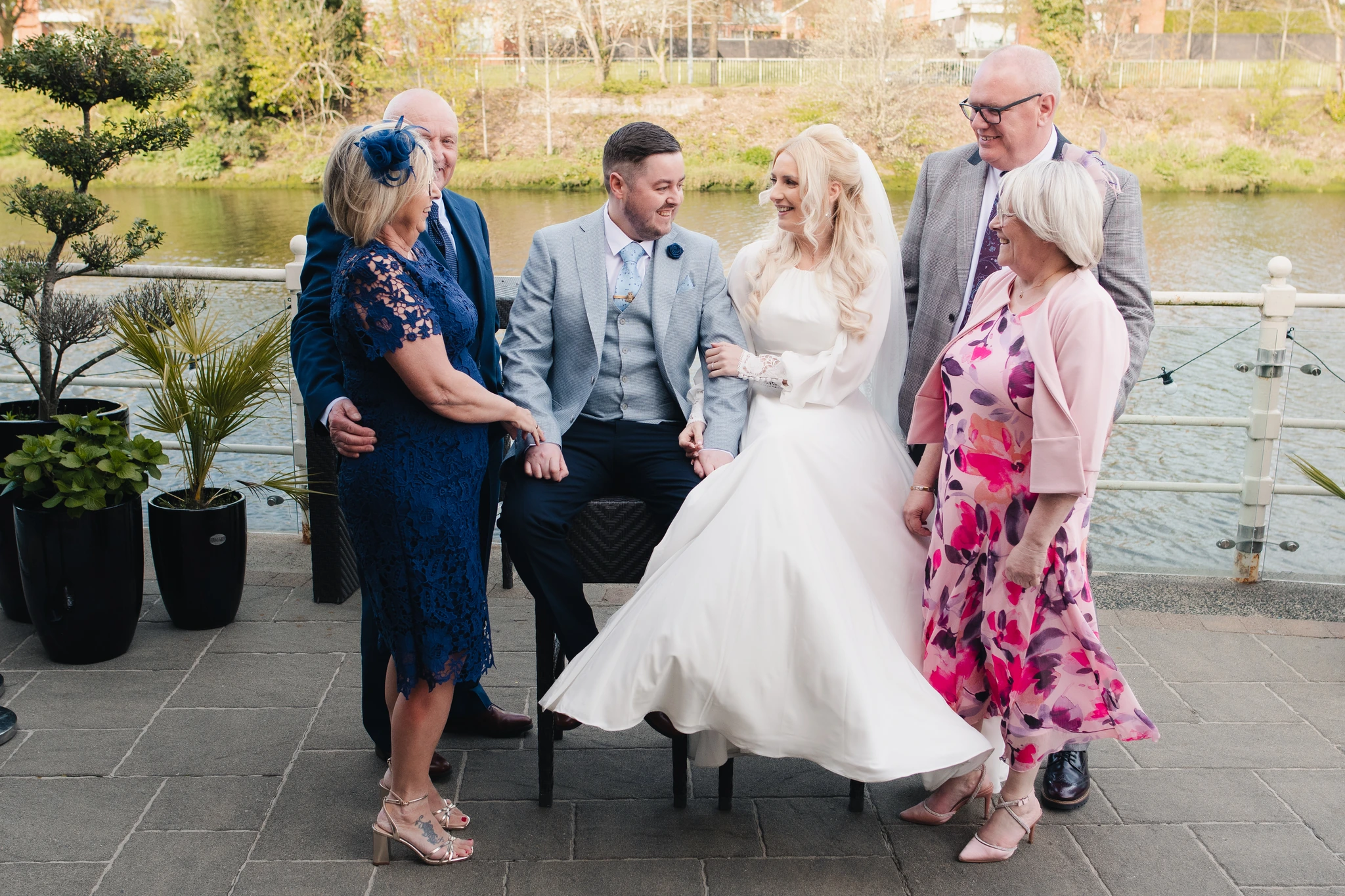 a group of family and friends posing by the river