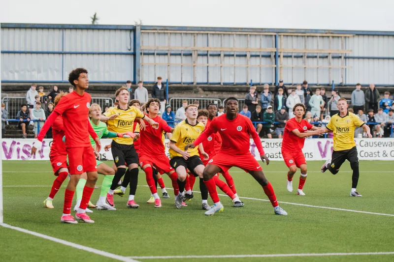 a group of young people playing soccer on a field
