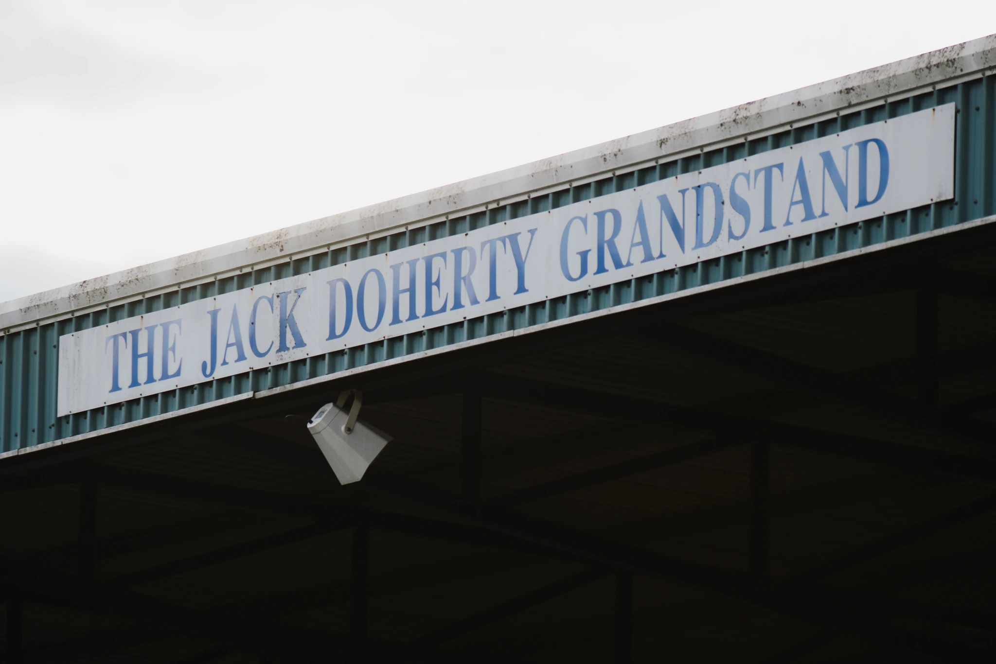 a sign on the side of a building that says jack dory grandstand