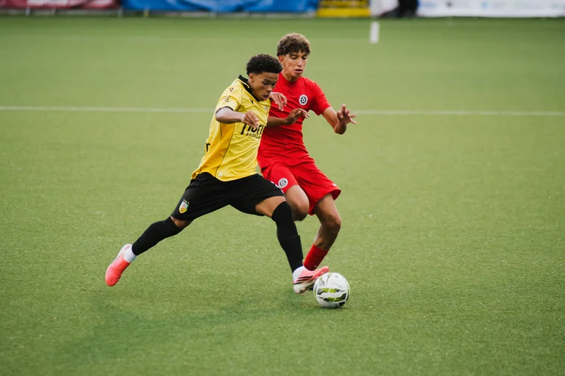 a soccer player in action during a match between two teams on a field