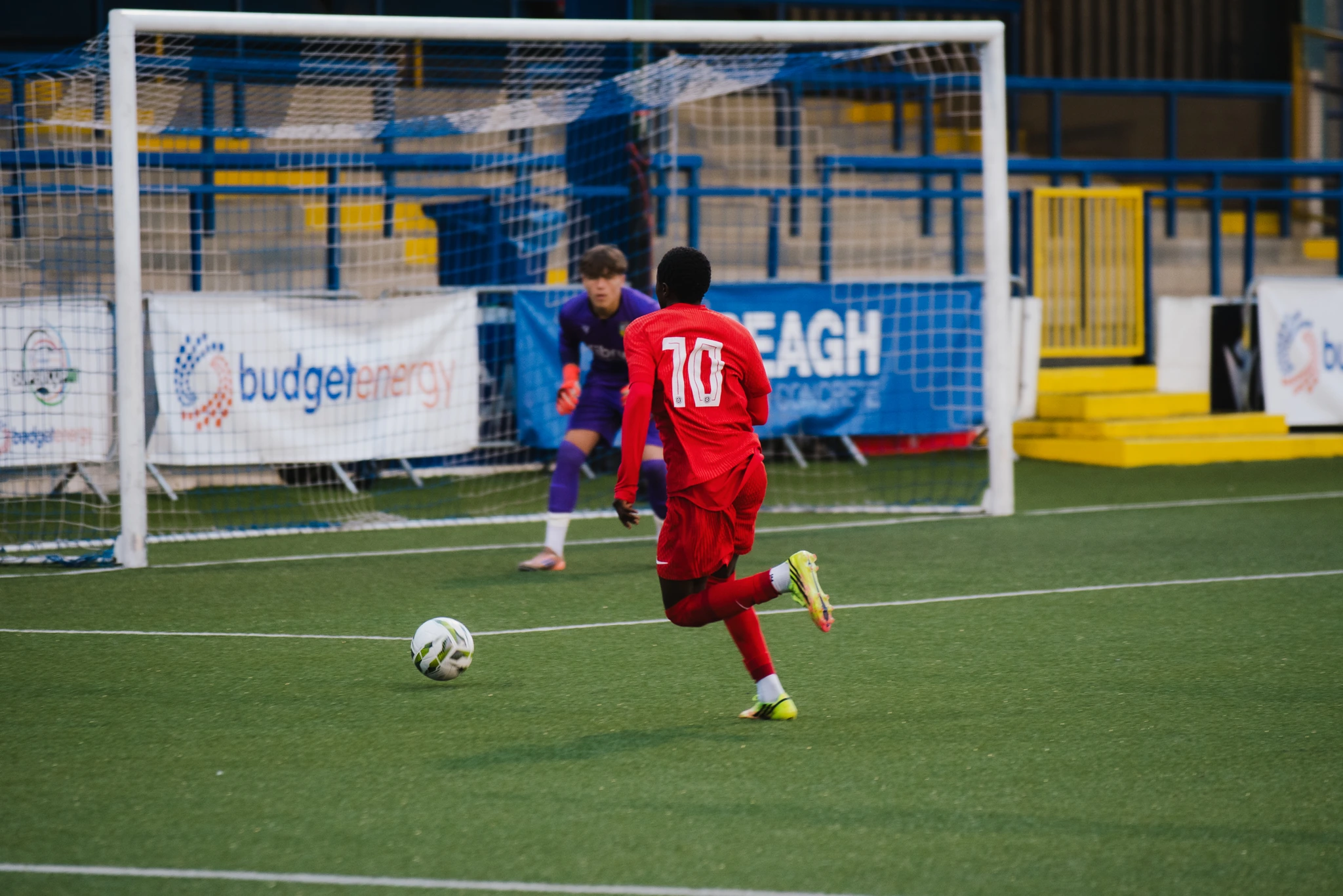 a soccer player is about to kick a ball into a goal