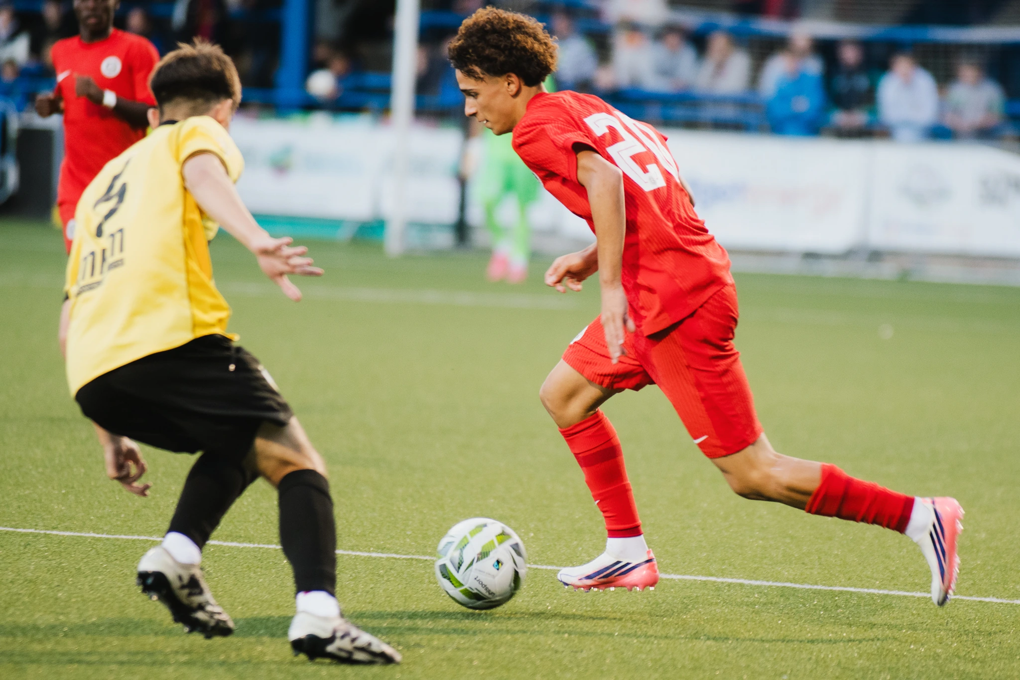 a soccer player in action on a field with a ball in his hands
