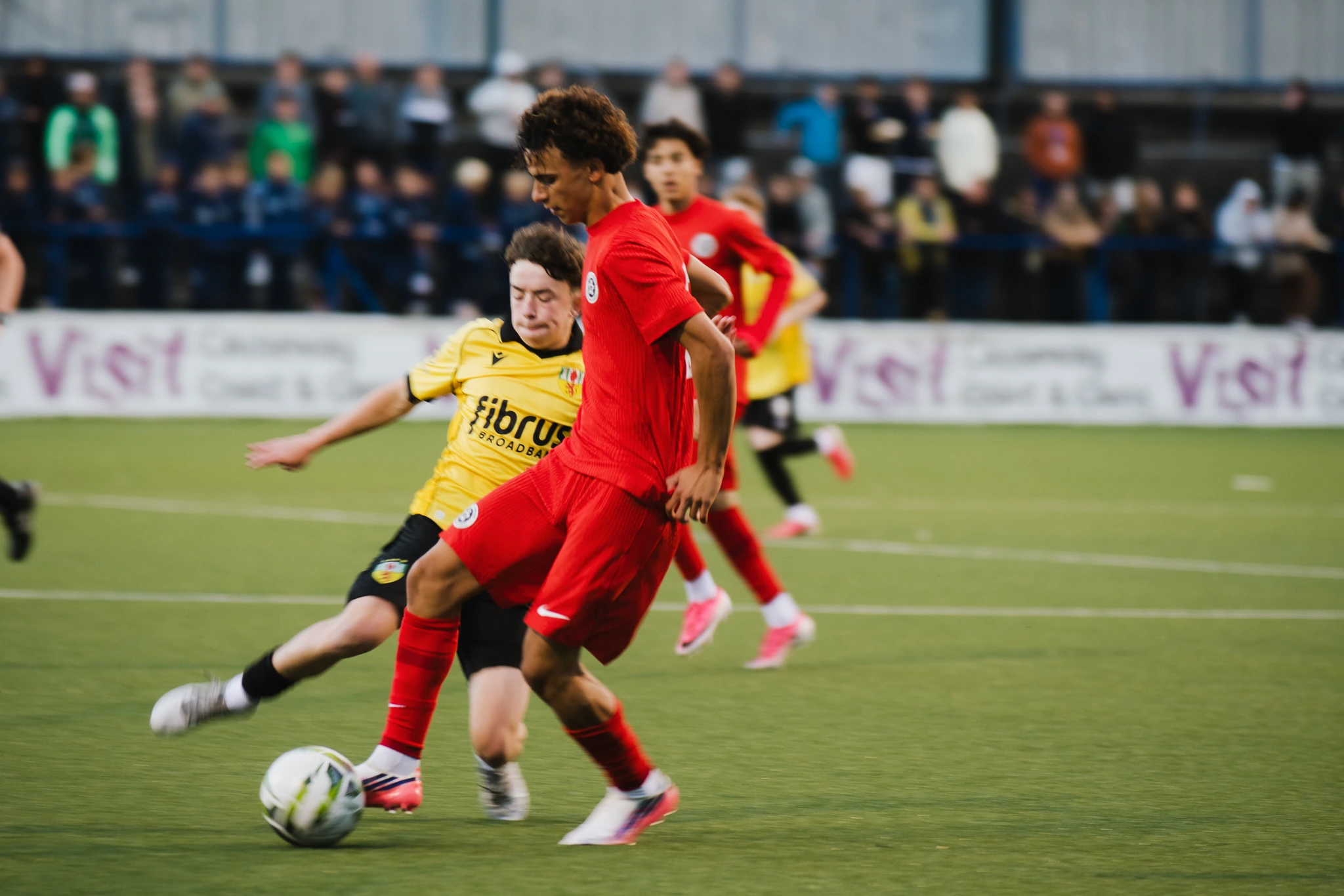 a group of young men playing soccer on a field