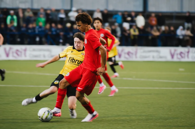 a group of young men playing soccer on a field