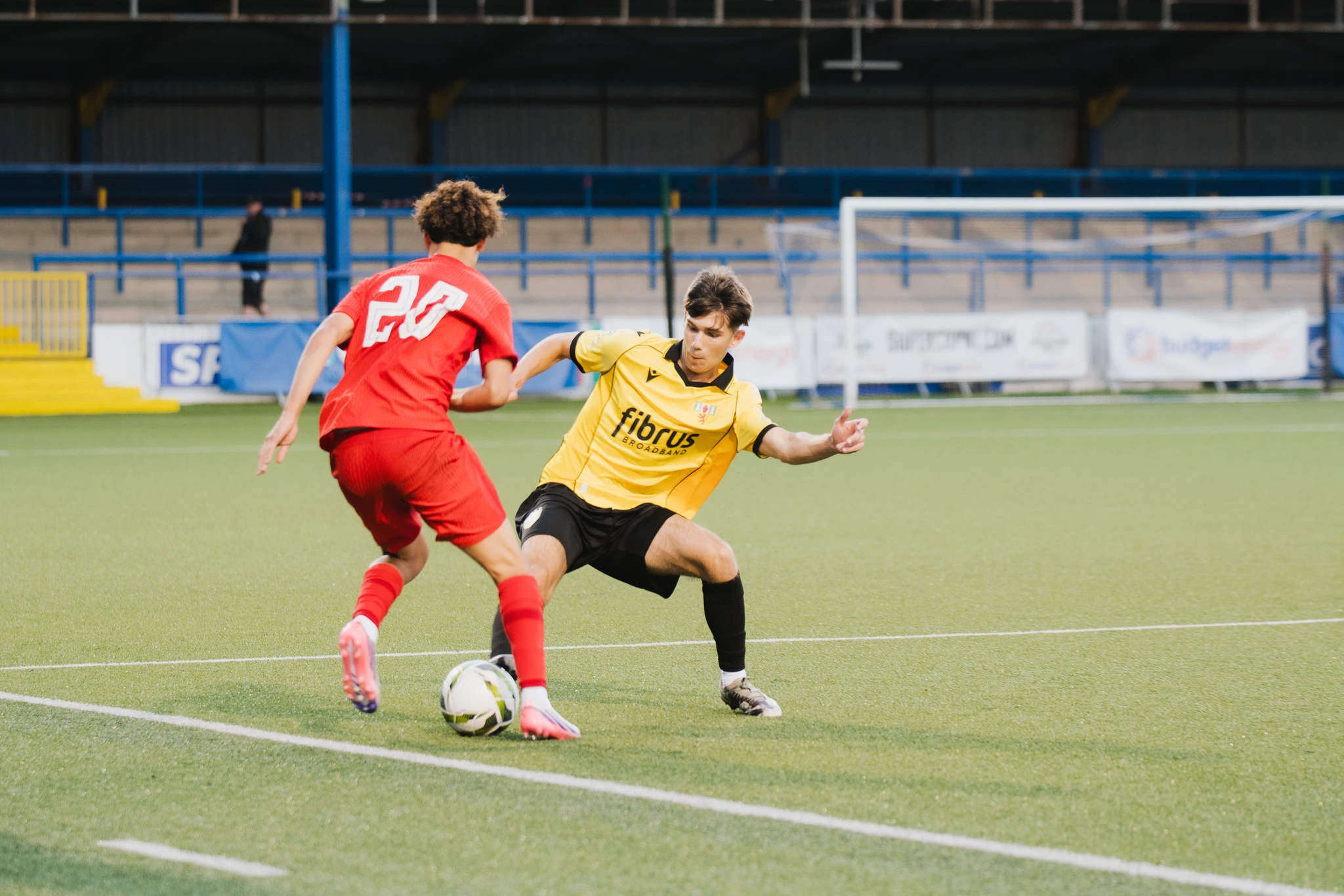 a soccer player in action during a match between two teams in a stadium