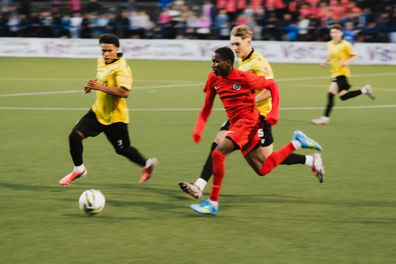 a group of young men playing soccer on a field