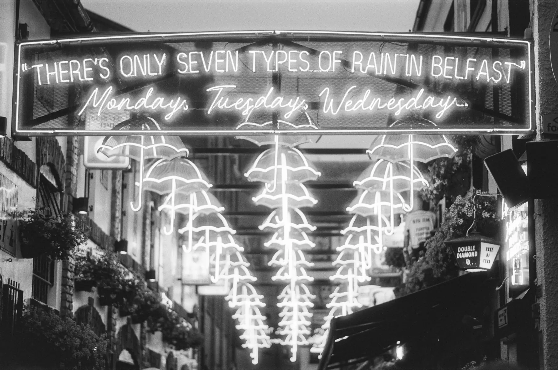 Illuminated Belfast street decorations reading There's only seven types of rain in Belfast.