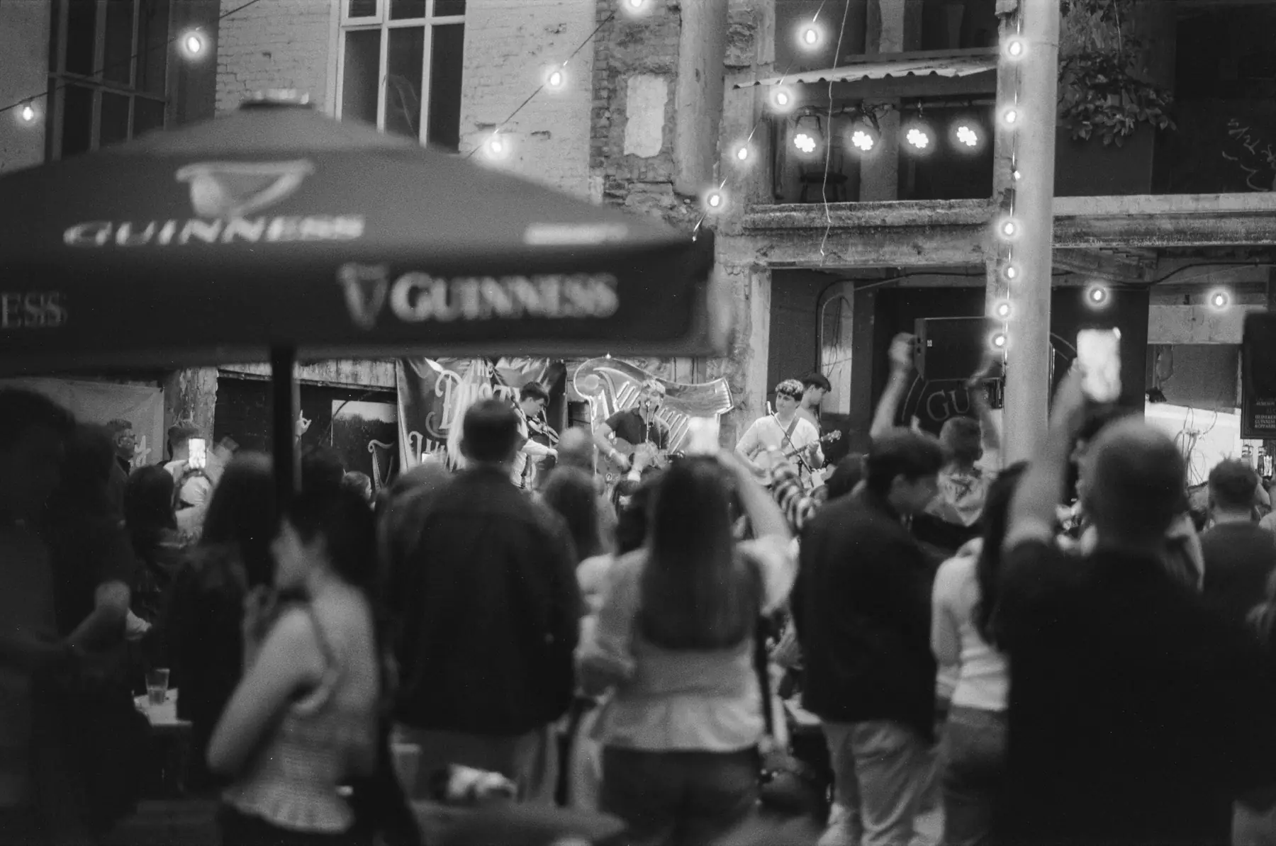 A crowd outside a Belfast pub at night during the Fleadh.